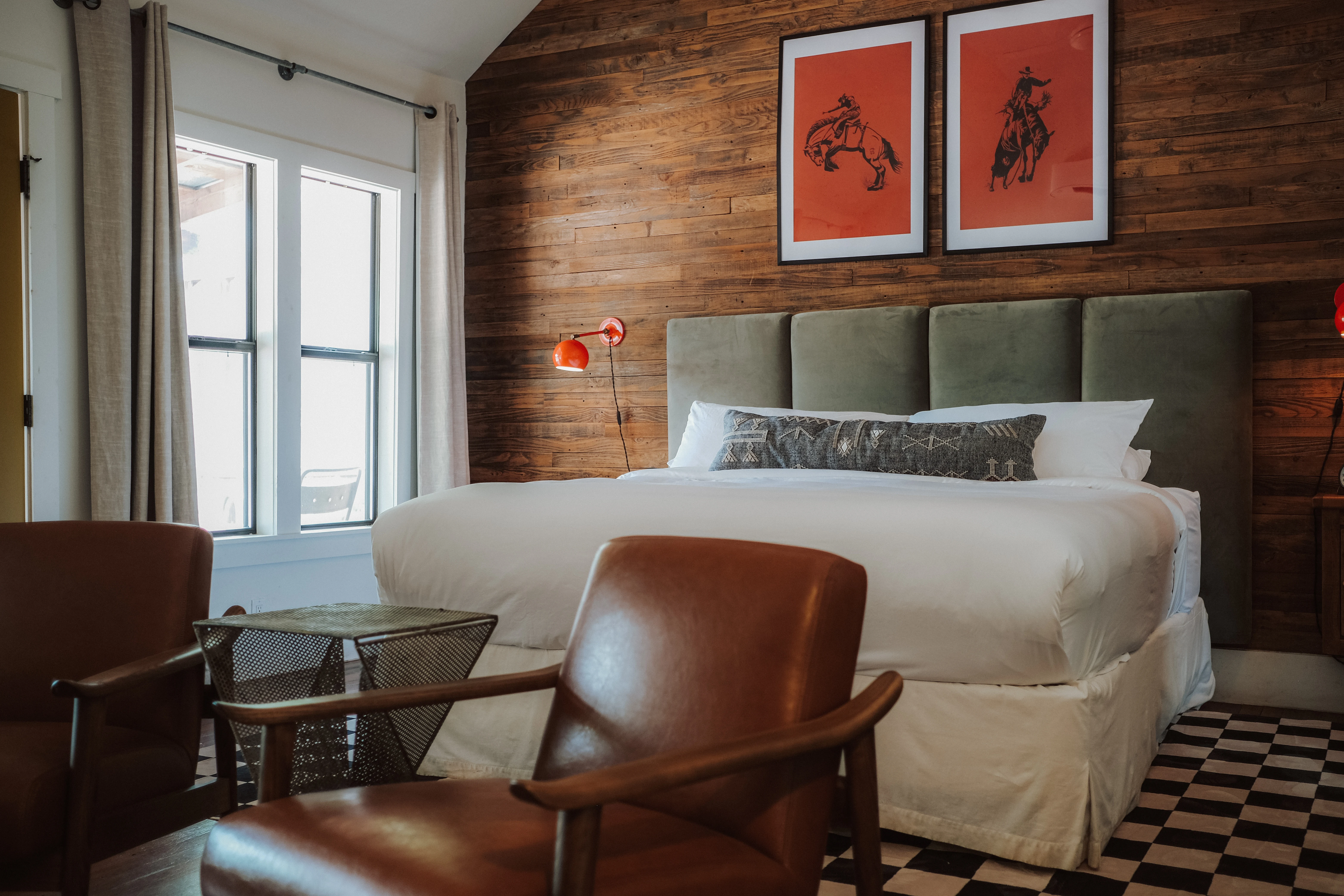 King room, rodeo prints on barnwood at Camp Comfort, hotel in Comfort, Texas