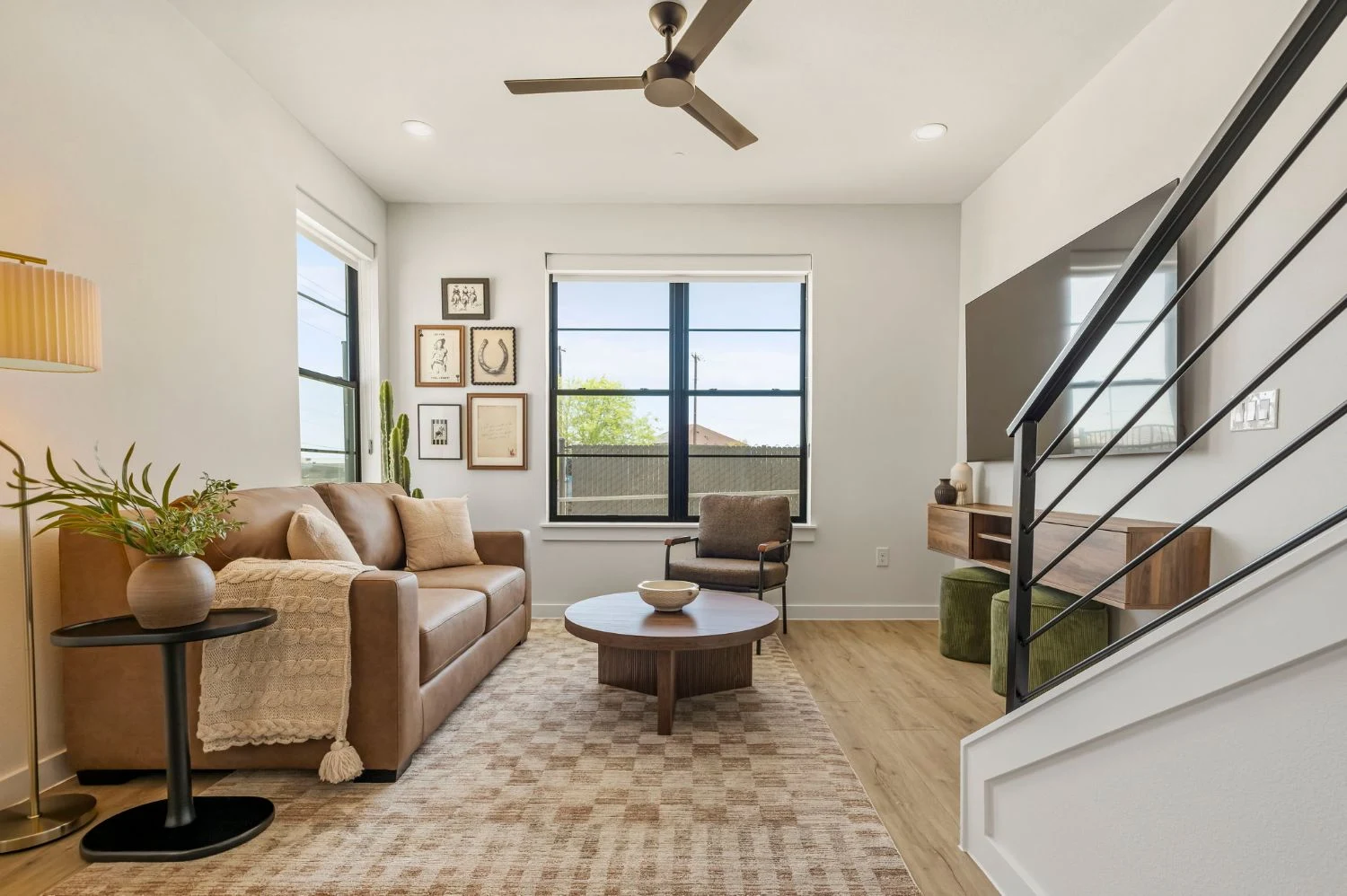 Living room, gallery wall & leather sofa at Dovetail, vacation rental in New Braunfels, Texas