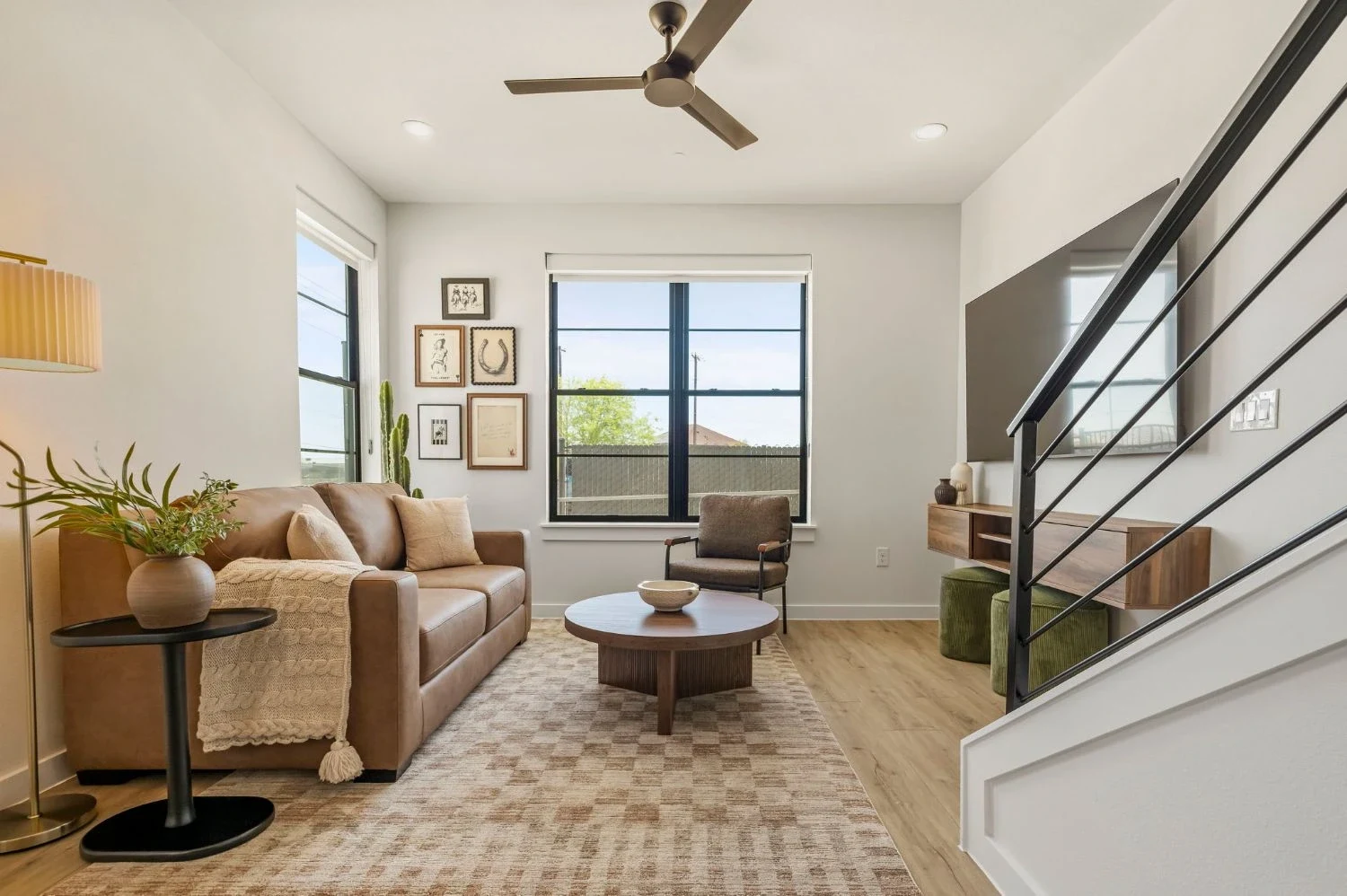 Living room, gallery wall & leather sofa at Dovetail, vacation rental in New Braunfels, Texas