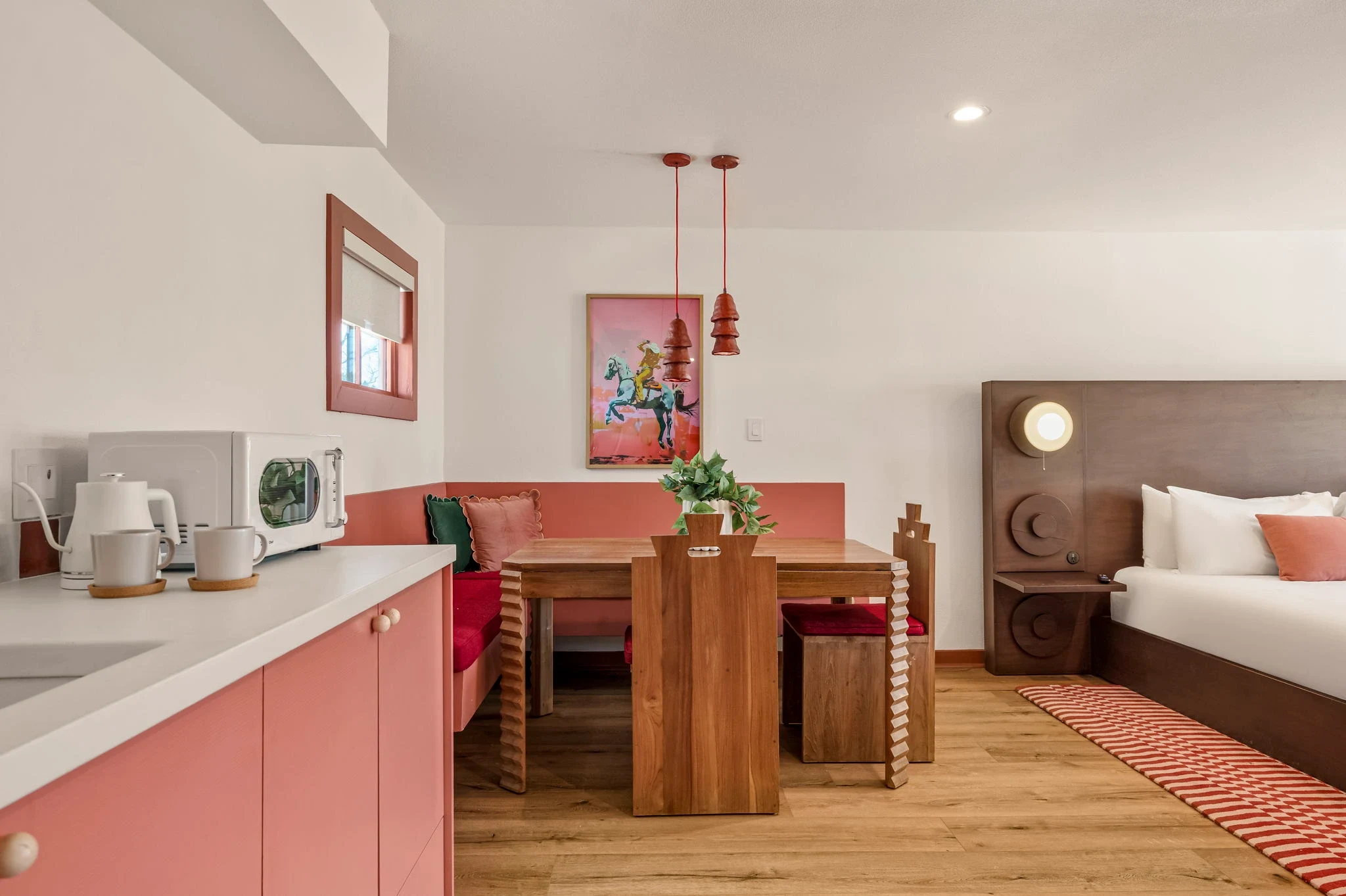 Clay pink banquette & the rodeo print at Hacienda del Rio, hotel in New Braunfels, Texas