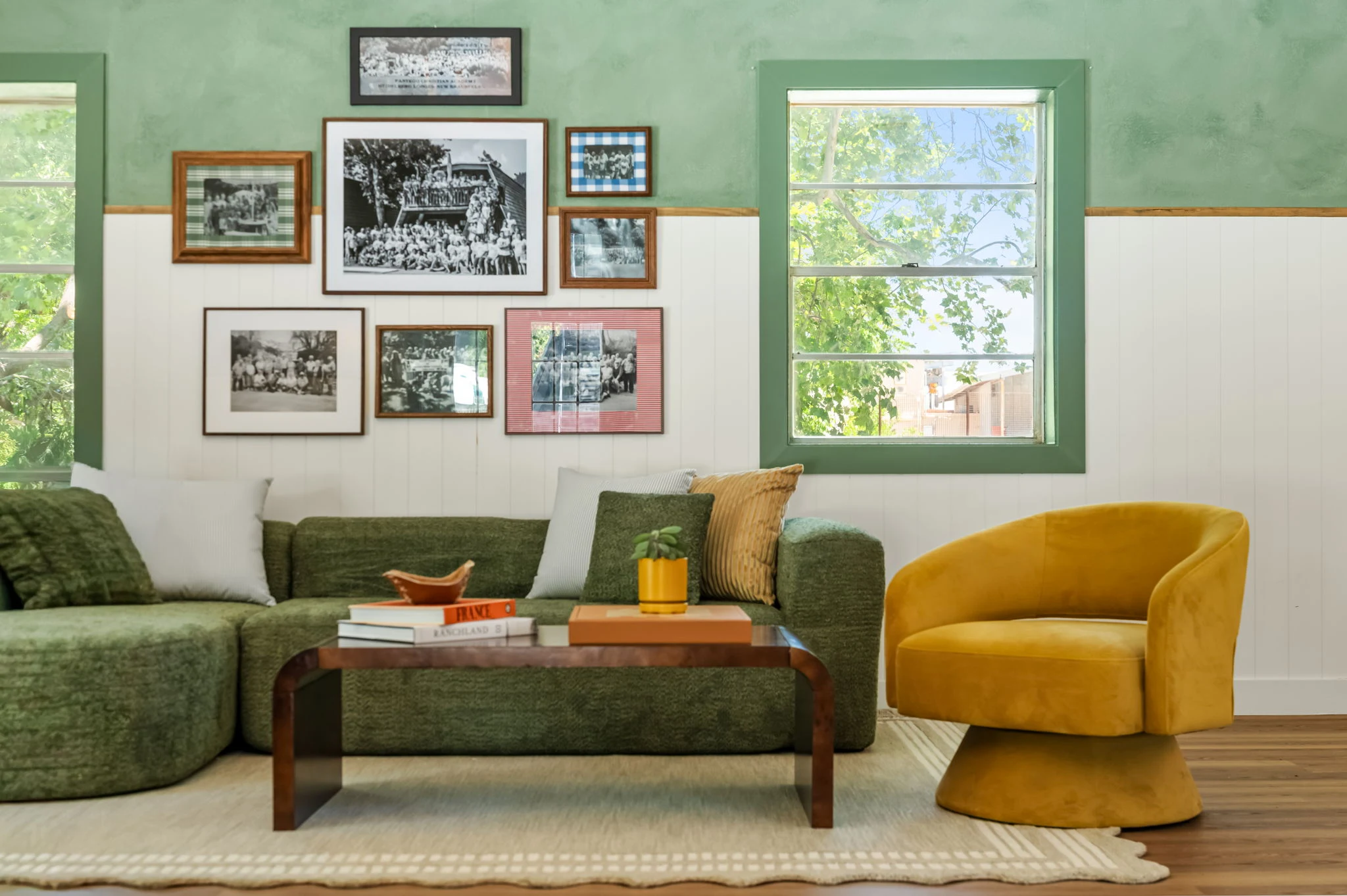 Gallery wall over the green sectional at Petit Cowboy, hotel in New Braunfels, Texas