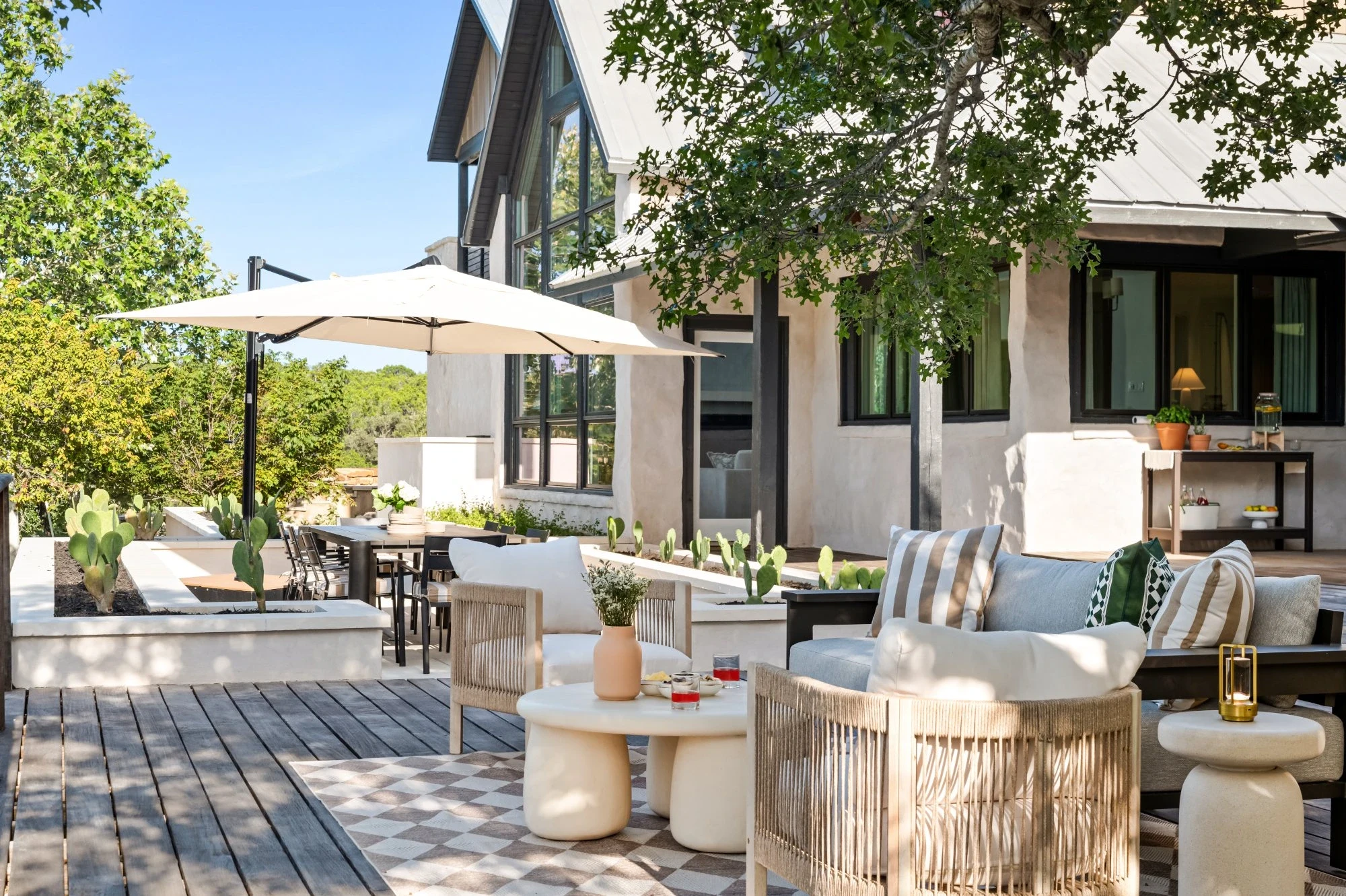 The deck under the oaks, laid out for a long afternoon at Valley Ridge, vacation rental